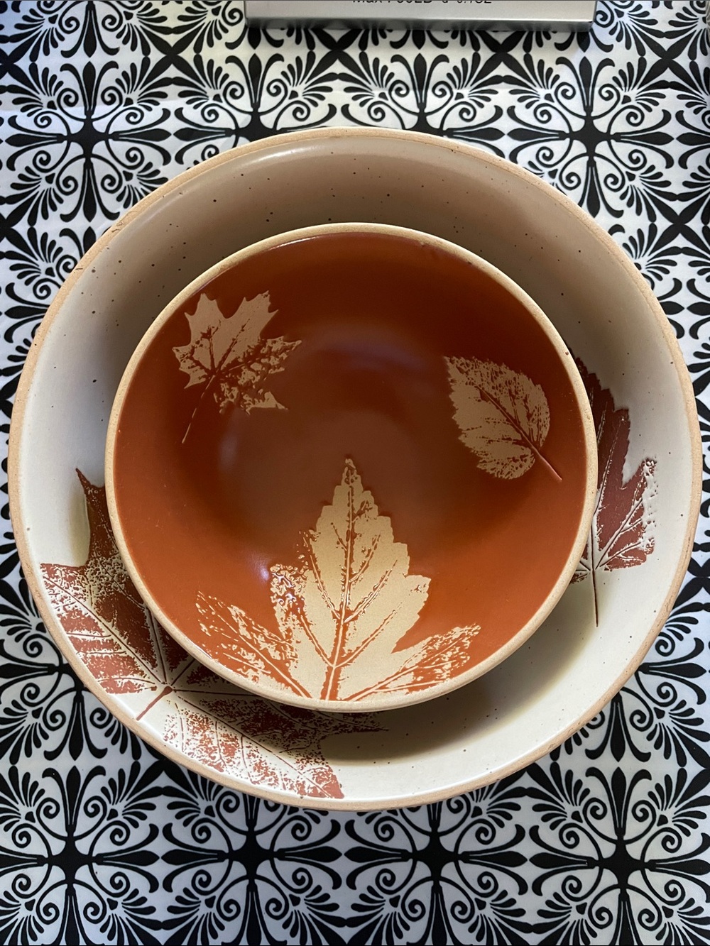 A nested set of two autumn-themed ceramic bowls by Primitives By Kathy.